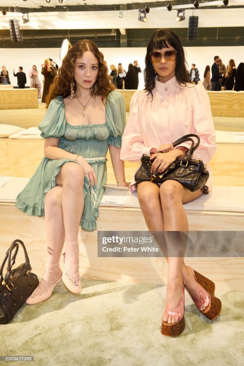 PARIS, FRANCE - MARCH 06: (EDITOR'S NOTE: Image contains partial nudity. EDITORIAL USE ONLY - For Non-Editorial use please seek approval from Fashion House) (L-R) Laufey and Courtney Eaton attends the Chloe Womenswear Fall/Winter 2025-2026 show as part of Paris Fashion Week  at Tennis Club de Paris on March 06, 2025 in Paris, France. (Photo by Peter White/Getty Images)