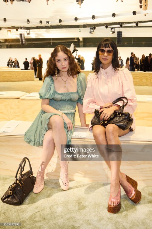 PARIS, FRANCE - MARCH 06: (EDITOR'S NOTE: Image contains partial nudity. EDITORIAL USE ONLY - For Non-Editorial use please seek approval from Fashion House) (L-R) Laufey and Courtney Eaton attends the Chloe Womenswear Fall/Winter 2025-2026 show as part of Paris Fashion Week  at Tennis Club de Paris on March 06, 2025 in Paris, France. (Photo by Peter White/Getty Images)