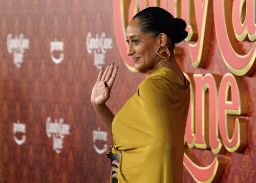 Tracee Ellis Ross waves to photographers at the premiere of the film "Candy Cane Lane" at the Regency Village Theatre, Tuesday, Nov. 28, 2023, in Los Angeles. (AP Photo/Chris Pizzello)