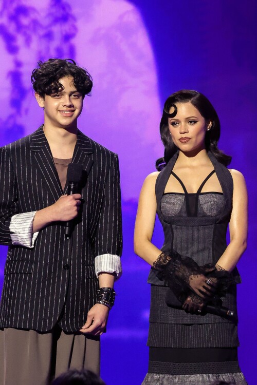 INGLEWOOD, CALIFORNIA - MAY 31: (L-R) Isaac Ordonez and Jenna Ortega speak onstage during NETFLIX TUDUM 2025: THE LIVE EVENT at The Kia Forum on May 31, 2025 in Inglewood, California. (Photo by Amy Sussman/Getty Images for Netflix)