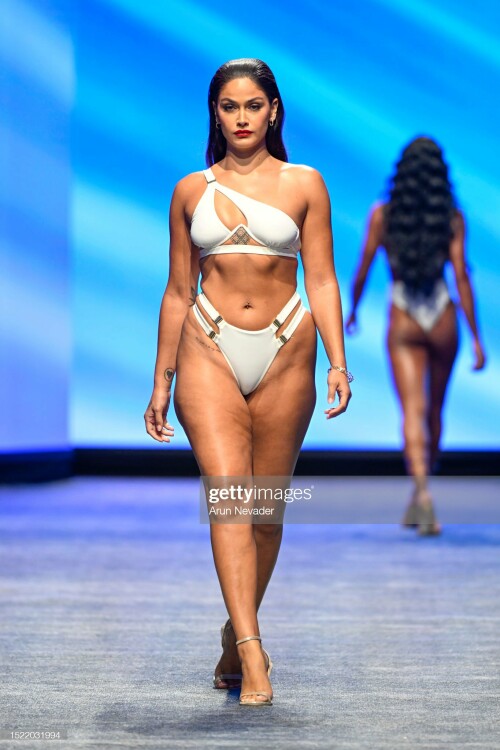 MIAMI BEACH, FLORIDA - JULY 06: A model walks the runway wearing Michael Costello during Miami Swim Week Powered by Art Hearts Fashion at Fontainebleau Hotel on July 06, 2023 in Miami Beach, Florida. (Photo by Arun Nevader/Getty Images for Art Hearts Fashion)