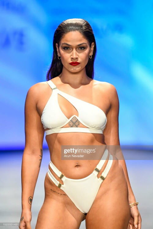 MIAMI BEACH, FLORIDA - JULY 06: A model walks the runway wearing Michael Costello during Miami Swim Week Powered by Art Hearts Fashion at Fontainebleau Hotel on July 06, 2023 in Miami Beach, Florida. (Photo by Arun Nevader/Getty Images for Art Hearts Fashion)