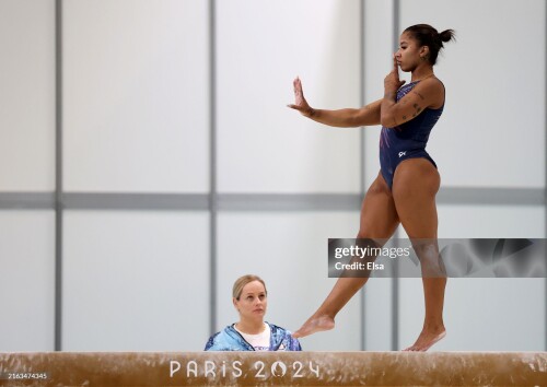 PARIS, FRANCE - JULY 24: Jordan Chiles of the USA practices on the beam as coach Cecile Landi looks on during a training session at the Paris-Le Bourget Exhibition Center on July 24, 2024 in Paris, France. (Photo by Elsa/Getty Images)