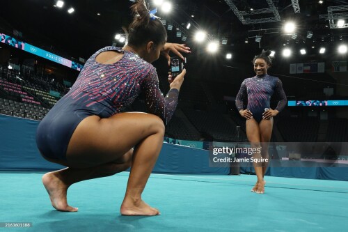 PARIS, FRANCE - JULY 25: Jordan Chiles of Team United States takes a photo of teammate Simone Biles during a Gymnastics training session in the Bercy Arena ahead of the Paris 2024 Olympic Games on July 25, 2024 in Paris, France. (Photo by Jamie Squire/Getty Images)