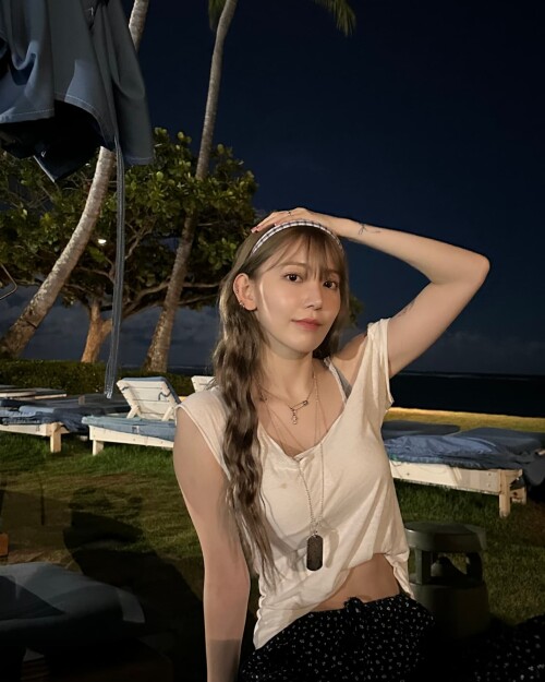 Photo by Sakura Miyawaki on September 24 2024. May be an image of 1 person hair beach and palm trees