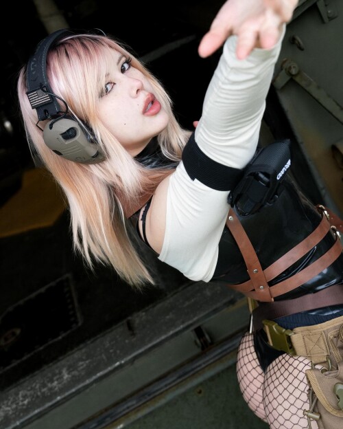 Photo by Syanne on April 15 2024. May be an image of 1 person gas mask fishnet stockings glasses cos