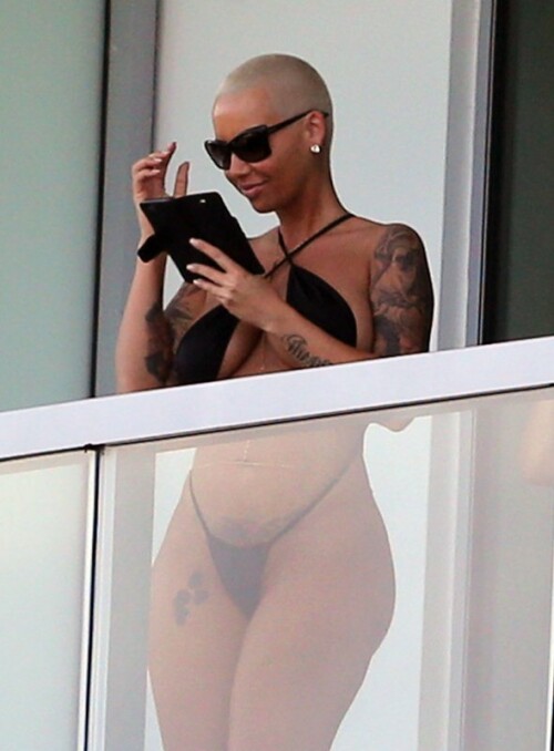 JANUARY 17, 2015: ***EXCLUSIVE*** Amber Rose poses in a miniscule thong bikini on her balcony in Miami.Mandatory Credit: INFphoto.com Ref: infusmi-11/13