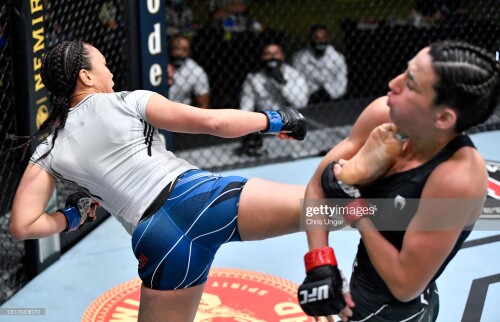 LAS VEGAS, NEVADA - MAY 08: (L-R) Michelle Waterson kicks Marina Rodriguez of Brazil in a flyweight fight during the UFC Fight Night event at UFC APEX on May 08, 2021 in Las Vegas, Nevada. (Photo by Chris Unger/Zuffa LLC)