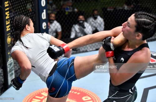 LAS VEGAS, NEVADA - MAY 08: (L-R) Michelle Waterson kicks Marina Rodriguez of Brazil in a flyweight fight during the UFC Fight Night event at UFC APEX on May 08, 2021 in Las Vegas, Nevada. (Photo by Chris Unger/Zuffa LLC)