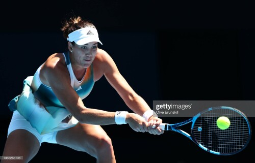 MELBOURNE, AUSTRALIA - JANUARY 18: Garbine Muguruza of Spain plays a backhand  in her first round singles match against Clara Burel of France during day two of the 2022 Australian Open at Melbourne Park on January 18, 2022 in Melbourne, Australia. (Photo by Clive Brunskill/Getty Images)