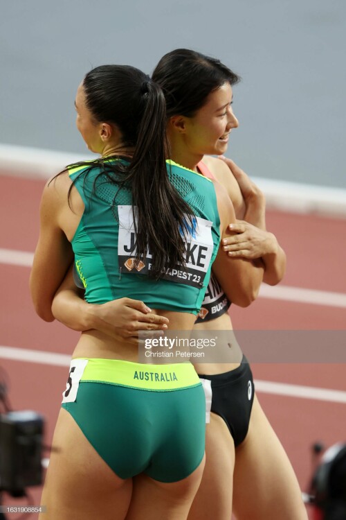 BUDAPEST, HUNGARY - AUGUST 22: Michelle Jenneke of Team Australia and Yumi Tanaka of Team Japan react after competing in the Women's 100m Hurdles Heats during day four of the World Athletics Championships Budapest 2023 at National Athletics Centre on August 22, 2023 in Budapest, Hungary. (Photo by Christian Petersen/Getty Images for World Athletics)