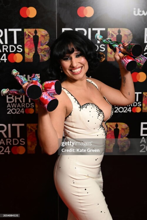 LONDON, ENGLAND - MARCH 02: (EDITORIAL USE ONLY. NO PUBLICATIONS DEVOTED EXCLUSIVELY TO THE ARTIST) Raye poses with their Best New Artist, R&B Act, Song of the Year, Artist of the Year, Album of the Year and Songwriter of the Year award in the winners room at the BRIT Awards 2024 at The O2 Arena on March 02, 2024 in London, England. (Photo by Kate Green/Getty Images)