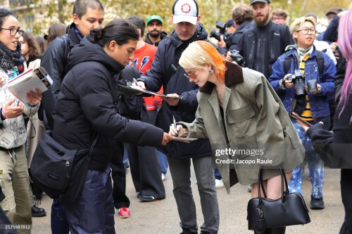 PARIS, FRANCE - SEPTEMBER 30: Hayley Williams signs autographs as she attends the Stella McCartney Paris Womenswear Spring-Summer 2025 show as part of Paris Fashion Week on September 30, 2024 in Paris, France. (Photo by Jacopo Raule/Getty Images)
