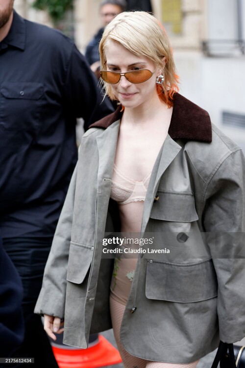 PARIS, FRANCE - SEPTEMBER 30: Hayley Williams wears olive green oversize jacket with brown collar, nude decorated underwear, outside Stella McCartney, during Womenswear Spring/Summer 2025 as part of  Paris Fashion Week on September 30, 2024 in Paris, France. (Photo by Claudio Lavenia/Getty Images)