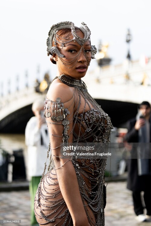 PARIS, FRANCE - JANUARY 29: Megan Thee Stallion wears a brown corset bodysuit, a silver face accessory and a see-through dress adorned with jewels outside the Gaurav Gupta show during Haute Couture Spring-Summer 2025 as part of  Paris Fashion Week on January 29, 2025 in Paris, France. (Photo by Valentina Frugiuele/Getty Images)