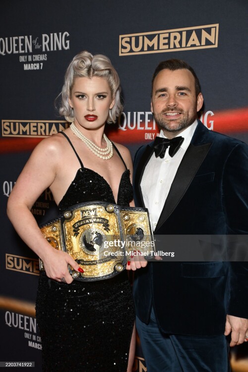LOS ANGELES, CALIFORNIA - MARCH 06: (L-R) Wrestler Toni Storm and director Ash Avildsen attend the Los Angeles premiere of "Queen Of The Ring" at AMC The Grove 14 on March 06, 2025 in Los Angeles, California. (Photo by Michael Tullberg/Getty Images)