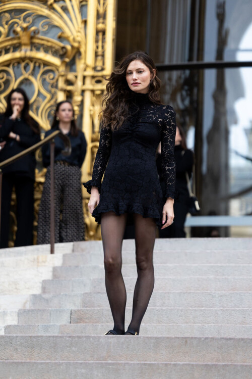 PARIS, FRANCE - MARCH 10: Phoebe Tonkin wears a black turtle neck long sleeved lace ruffles mini dress, black tights and black shoes outside Zimmermann show during the Womenswear Fall/Winter 2025/2026 as part of Paris Fashion Week on March 10, 2025 in Paris, France. (Photo by Valentina Frugiuele/Getty Images)