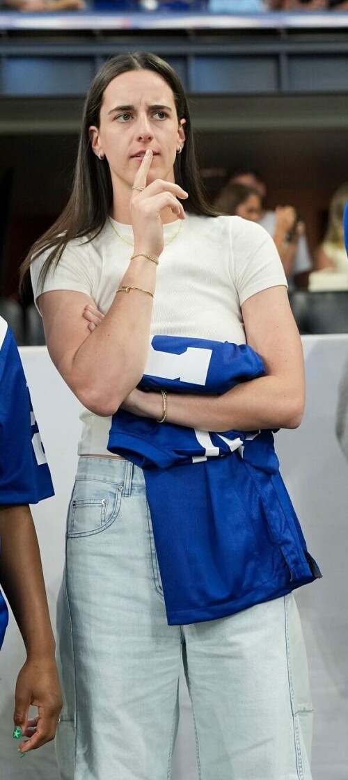 INDIANAPOLIS, INDIANA - OCTOBER 5:  Caitlin Clark (2L) of the Indian Fever looks on prior to an NFL football game between the Indianapolis Colts and the Las Vegas Raiders at Lucas Oil Stadium on October 5, 2025 in Indianapolis, Indiana. (Photo by Todd Rosenberg/Getty Images)