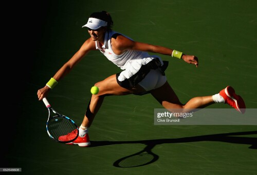 INDIAN WELLS, CA - MARCH 12:  Garbine Mugaruza of Spain in action against Kayla Day of the United States in their third round match during day seven of the BNP Paribas Open at Indian Wells Tennis Garden on March 12, 2017 in Indian Wells, California.  (Photo by Clive Brunskill/Getty Images)