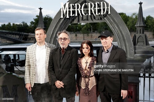 (From L) British screenwriter Miles Millar, US director Tim Burton, US actress Jenna Ortega and US screenwriter and film producer Alfred Gough pose during the premiere of the second Season of the supernatural mystery Netflix TV series "Wednesday" in Paris on July 31, 2025.  (Photo by STEPHANE DE SAKUTIN / AFP) (Photo by STEPHANE DE SAKUTIN/AFP via Getty Images)