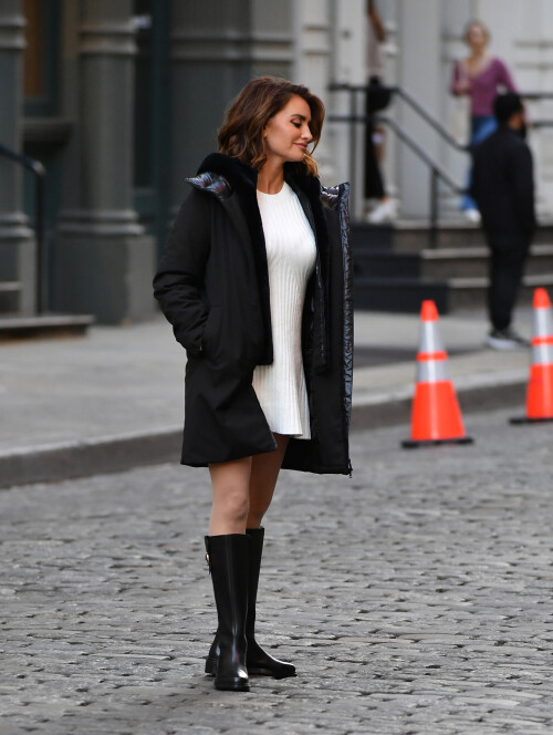 20 April 2024 - EXCLUSIVE.Penelope Cruz strikes a pose during a photoshoot in the SoHo neighborhood on New York City. The 49 year old Spanish actress modeled a black jacket, white dress, and black boots for the Geox fashion label.Credit: GoffPhotos.com   Ref: KGC-339/TIDNY-195**UK Sales Only - No Daily Mail Group/No Sun Group - Exclusive - Newspapers Allrounder - Magazines Double Space Rates - Web/Online Must Call Before Use**