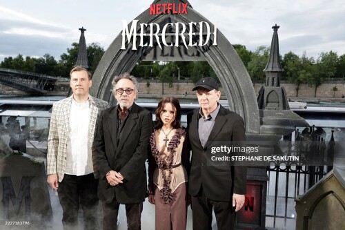 (From L) British screenwriter Miles Millar, US director Tim Burton, US actress Jenna Ortega and US screenwriter and film producer Alfred Gough pose during the premiere of the second Season of the supernatural mystery Netflix TV series "Wednesday" in Paris on July 31, 2025.  (Photo by STEPHANE DE SAKUTIN / AFP) (Photo by STEPHANE DE SAKUTIN/AFP via Getty Images)
